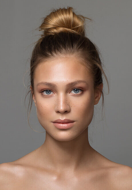 An image of a woman showing her face after undergoing facial procedures